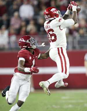 Nov 20, 2021; Tuscaloosa, Alabama, USA; Arkansas Razorbacks wide receiver Treylon Burks (16) makes a catch over Alabama Crimson Tide defensive back Kool-Aid McKinstry (1) at Bryant-Denny Stadium. Alabama won 42-35. Mandatory Credit: Gary Cosby Jr.-USA TODAY Sports